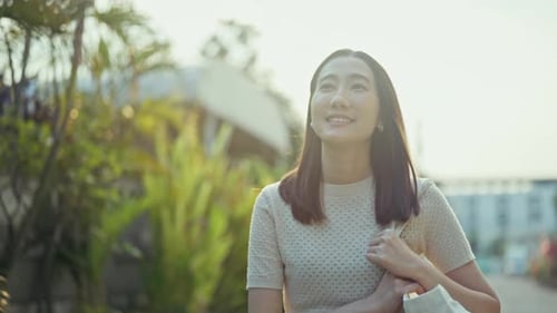 Smiling Woman Walking on Sunny Suburban Street