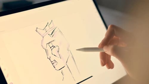 Woman drawing on a tablet with white pencil, close up