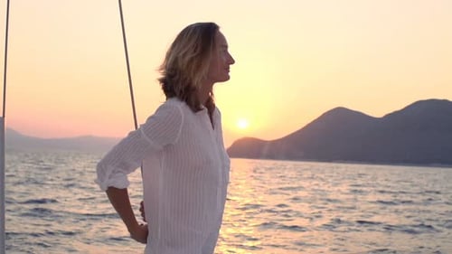 Young Woman Enjoying Sailing Boat on Sea During Sunset Admire