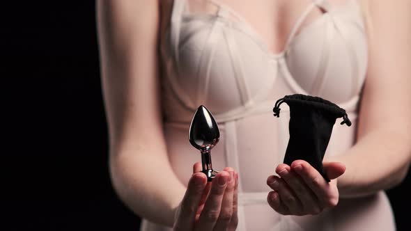 Woman Showing Shiny Metal Object from Bag Woman Showing Shiny Metal Object from Bag