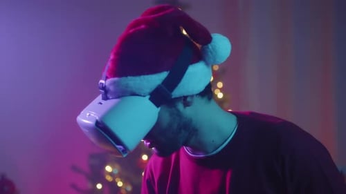 Man in Santa Hat Using Virtual Reality Headset