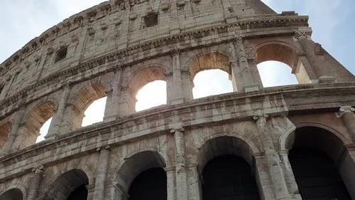 A ray of sun passes through the arches of the Colosseum in Rome, Italy.