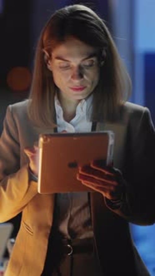 A Professional Businesswoman Utilizing a Tablet Within a Sleek and Modern Workspace Environment