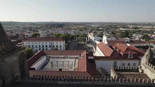 Drone flying over Evora Cathedral with old roman ruins temple in background, Portugal. Aerial revers