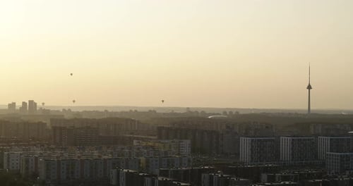 Hot air balloons over Vilnius skyline. Summer morning, drone aerial view