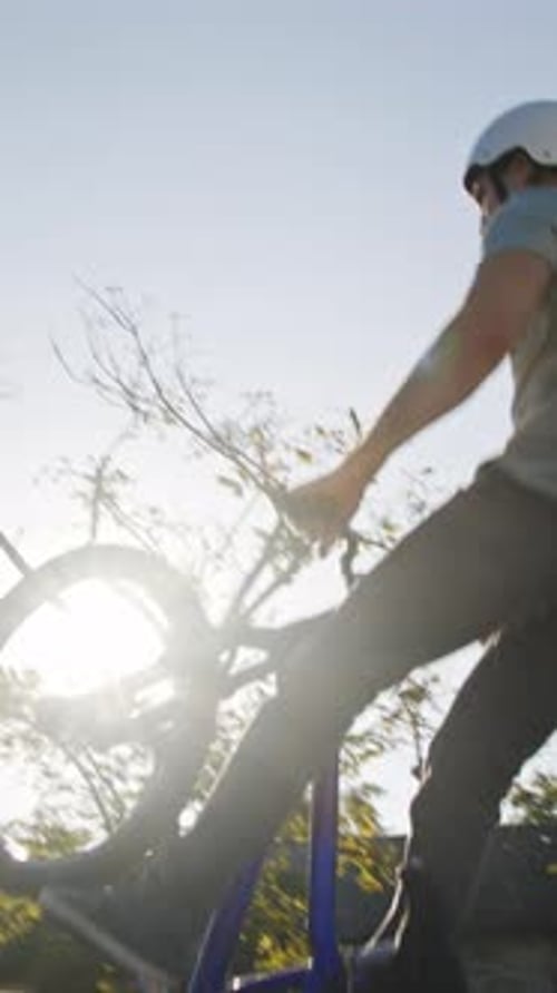 Man on bike doing trick in skate park