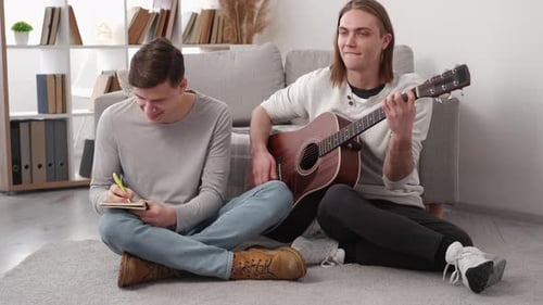 Two Friends Compose Music Together in a Home