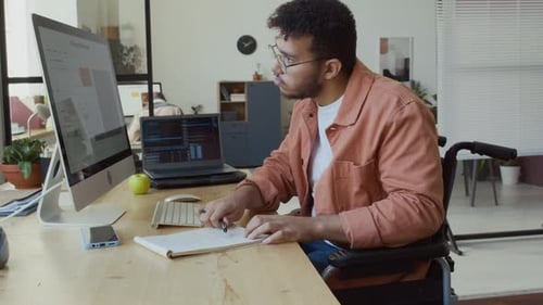 Young Male Programmer in Wheelchair Testing Software Algorithm