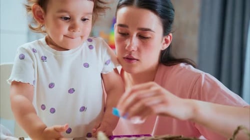 Toddler and Woman Play Together Indoors at Home