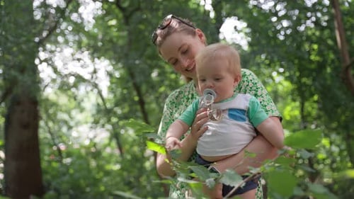 Cute Baby Touching The Leaves