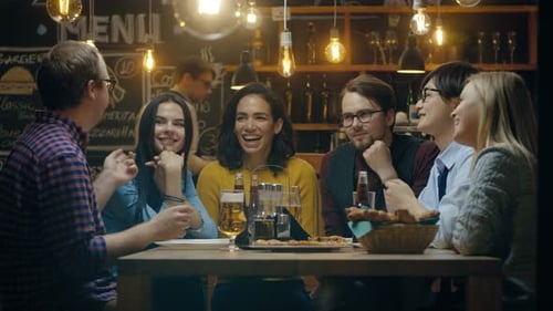 Diverse Group of Young People Have Fun in Bar, Have Conversation, Telling Stories and Jokes. They D