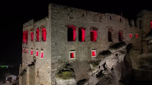 Medieval Ogrodzieniec castle on the rock with a walls, during a dark night.