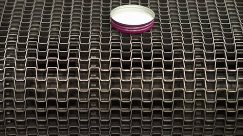 Bottle Caps Dropping Off Cap Lining Conveyor Belt