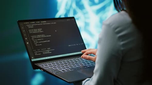 Close Up Shot of IT Expert Using AI System and Laptop