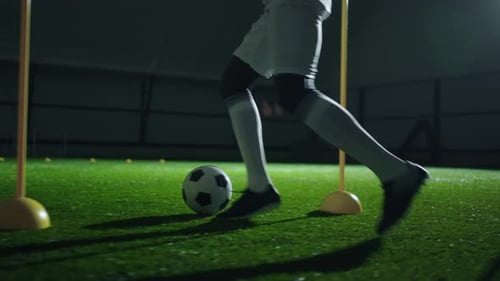 Professional Football Player Practicing Dribbling Tricks in Stadium Closeup View of Feet and Ball