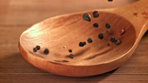 Multicolor Peppercorns Falling Into Wooden Spoon