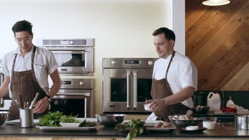 Chef Peeling A Potato Into A Bowl In Interior Kitchen With Soft Day Lighting. Close Up To Wide Sh...