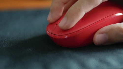 Close-up of male hand clicking mouse.
