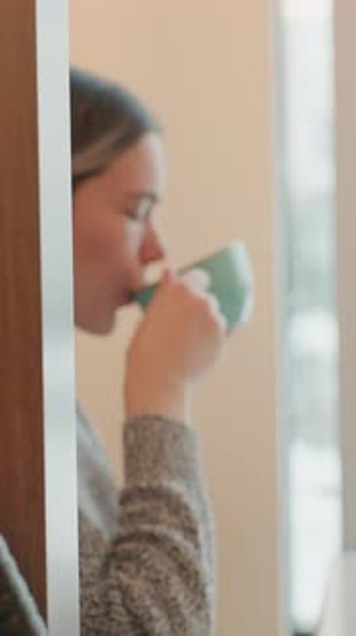 Woman Enjoying Coffee in Cozy Home Setting