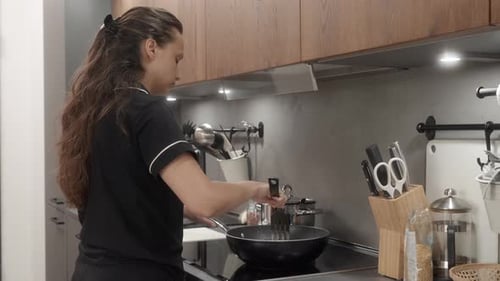 Woman Cooking Food in Kitchen Frying Pan