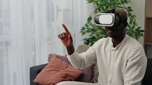 Young Adult Enjoys Virtual Reality Experience with Headset