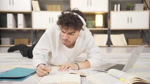 Young Adult Studying with Laptop on Floor