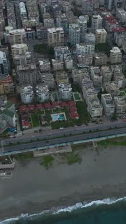 Vertical Video Aerial Perspective of a Scenic Town on the Mediterranean Coast With Urban and Ocean