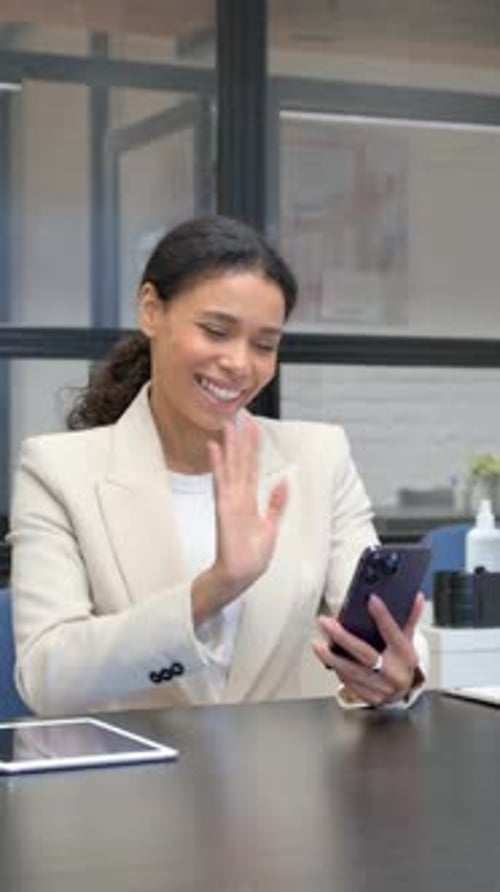 African Woman Doing Video Chat on Phone in Office, vertical video