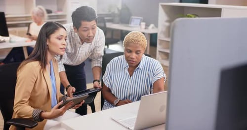 Discussing work, diverse team collaborating on project using laptop and tablet in office