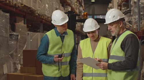 Warehouse Manager Speaking to Employees at Workplace