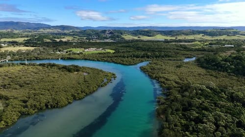 Dolly aerial of Minnamurra River winding through coastal wetlands, NSW