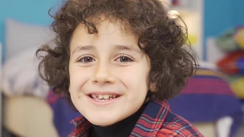 Happy Child Smiling in Bedroom