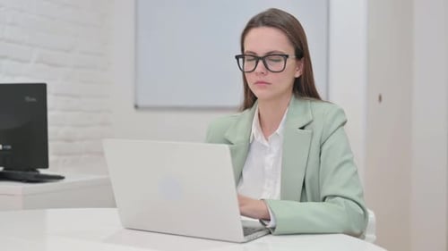Business Woman Looking at Camera in Office