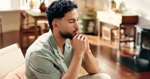 Home, thinking and man in lounge, relax and break with contemplation, memory and daydreaming