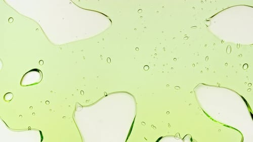 Transparent Green Cosmetic Gel Fluid With Molecule Bubbles and Oil on White Background