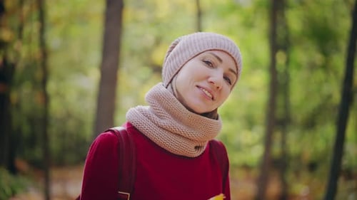 Portrait of a Young Woman Walking in a Vibrant Autumn Forest An Attractive Woman Dressed in a Red
