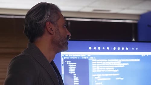 Male Computer Programmer Talking at Screen with Computer Code 4044 Years