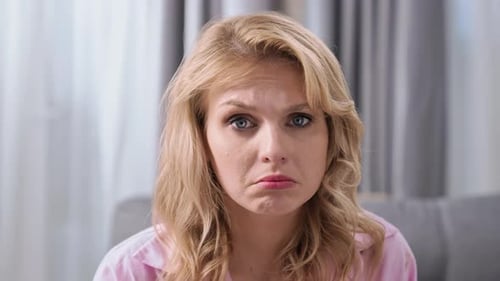 Sad Woman Looks at the Camera Close Up