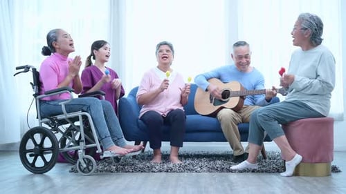Seniors Singing and Playing Instruments with Caregiver