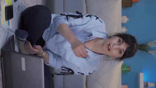Vertical video of Home office worker woman looking at camera confused.