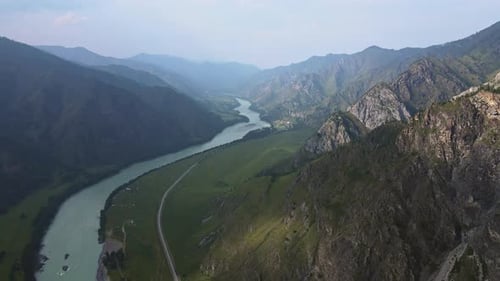 Aerial View of the Valley with the River Surrounded By High Mountains
