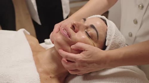 Woman Receives Facial Massage at Cosmetology Clinic