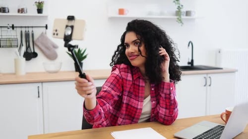 Young Adult Woman Filming Herself in Kitchen