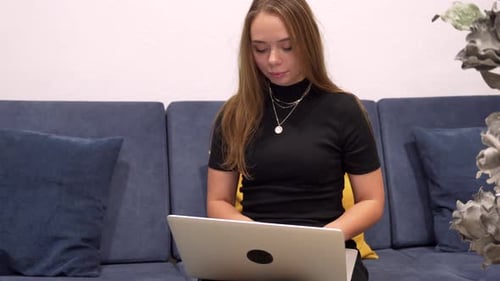 Young Female Freelancer Works Remotely Beautiful Slavic Millennial Looks at Laptop Screen and