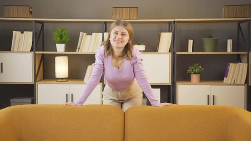 Happy Woman Smiling Behind Yellow Couch
