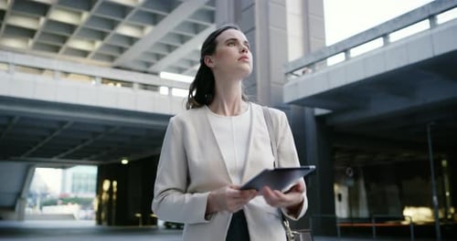 Woman Uses Tablet in Modern Urban Environment