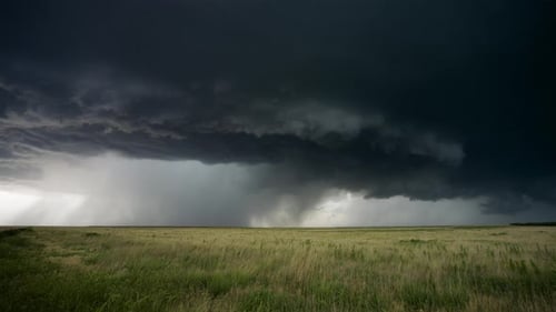 Storm Clouds Rolling Over Grassy Field Landscape