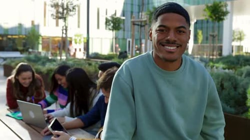 Portrait of Young Happy African American Man Standing at College Campus