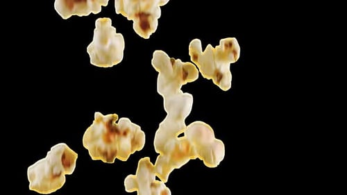 Popcorn grains falling. Slow motion. Alpha channel included.
