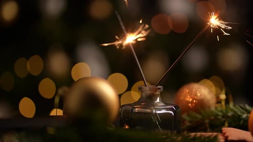 Sparkling Sparklers and Christmas Ornaments at Night
